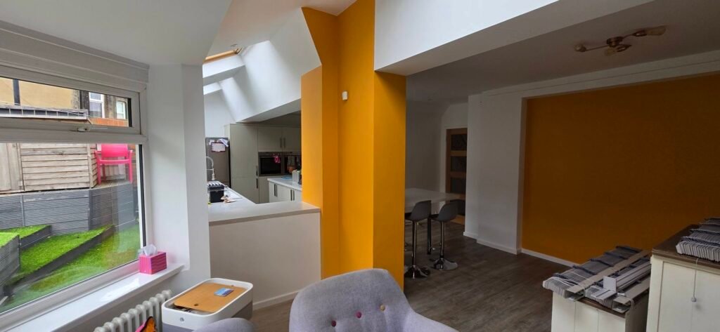 Bold orange feature wall in an open-plan kitchen extension