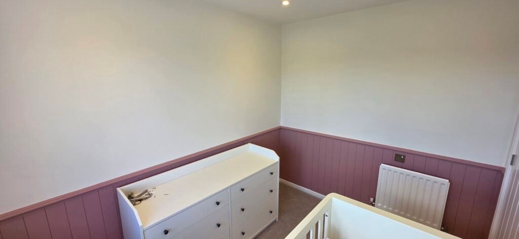 Painted tongue-and-groove panelling in a nursery